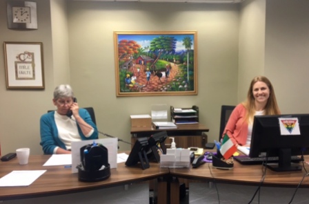 Guest services coordinator, Erin Chubb (right), and a volunteer welcome visitors into the Irish International Immigrant Center.